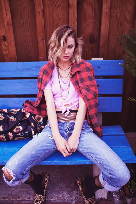woman in plaid shirt on bench