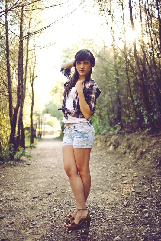 woman in plaid shirt on forest path