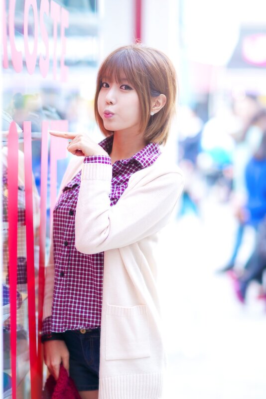woman in plaid shirt pointing