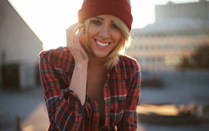 Woman in Plaid Shirt — Red, Warm, Sunset, Photograph, Beanie, Tattoo, Building
