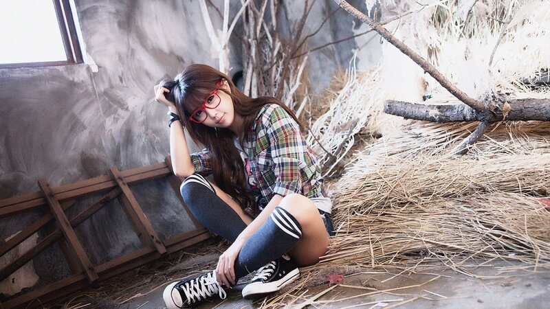woman in plaid shirt sitting on hay