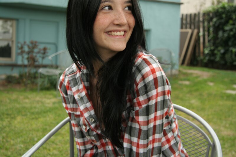 woman in plaid shirt smiling