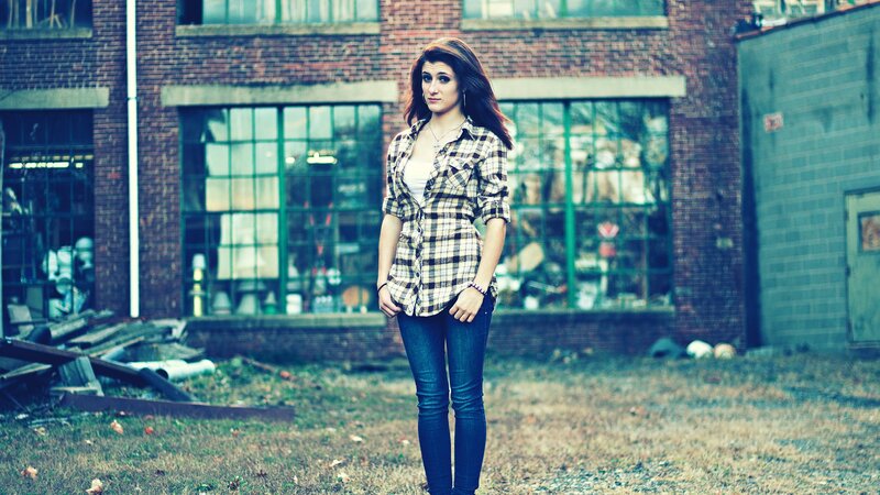 woman in plaid shirt standing outside