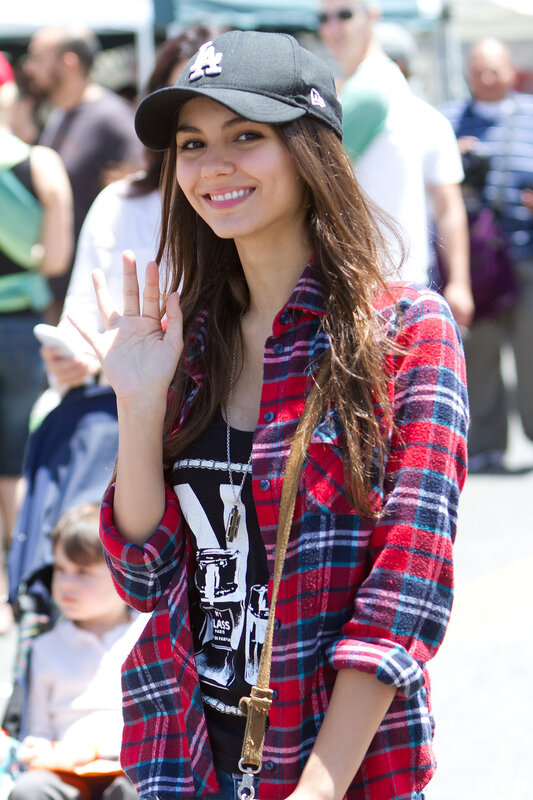 woman in plaid shirt waving