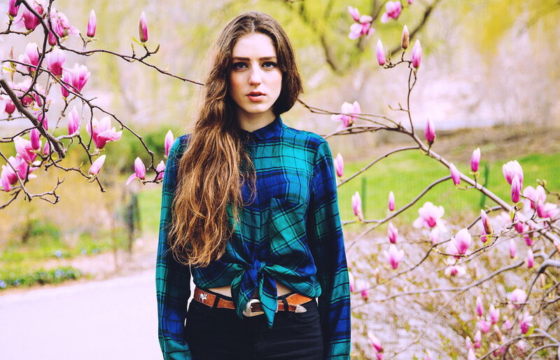 Woman in plaid shirt with magnolias