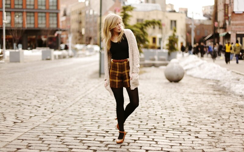 woman in plaid shorts on cobblestone street