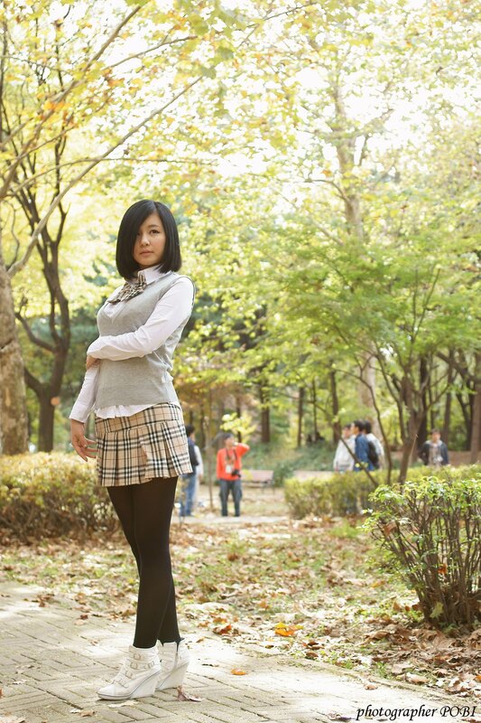 Woman in Plaid Skirt — Green, Serene, Autumn, Photograph