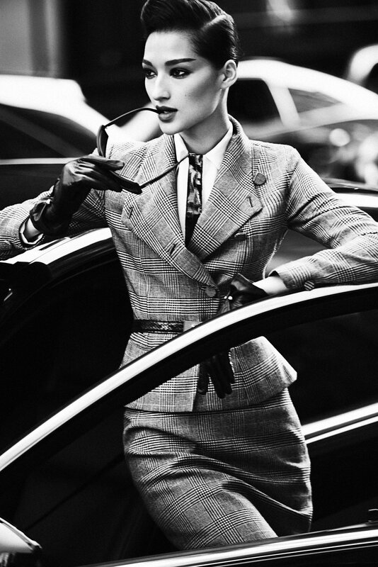 woman in plaid suit exiting car