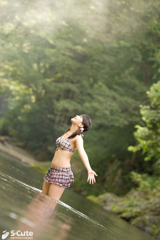Woman in plaid swimsuit by river