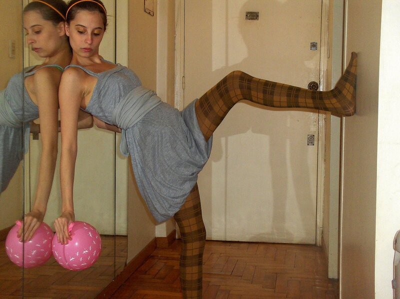 woman in plaid tights stretching