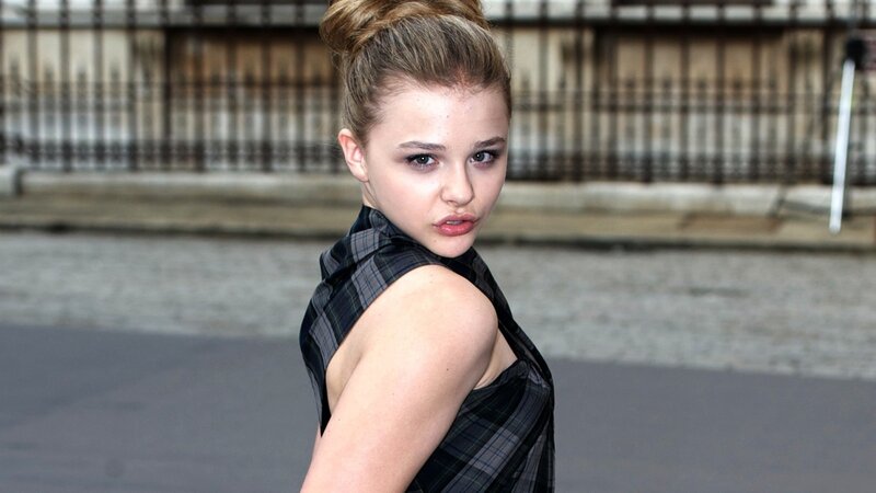 woman in plaid top looking back