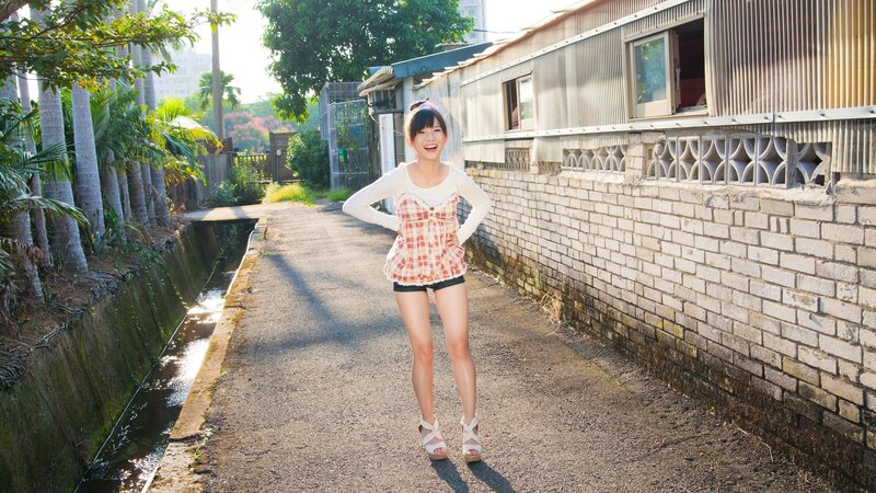 Woman in plaid top on a path
