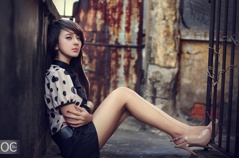 woman in polka dot blouse sitting