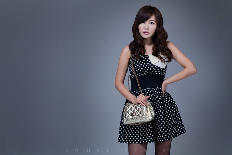 Woman in Polka Dot Dress — Black, Confident, Photograph, Handbag