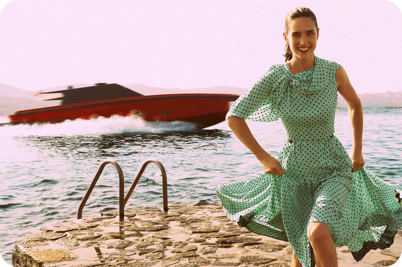 Woman in polka dot dress by the water