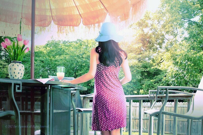 Woman in polka-dot dress on patio