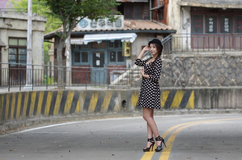 Woman in polka dot dress on street