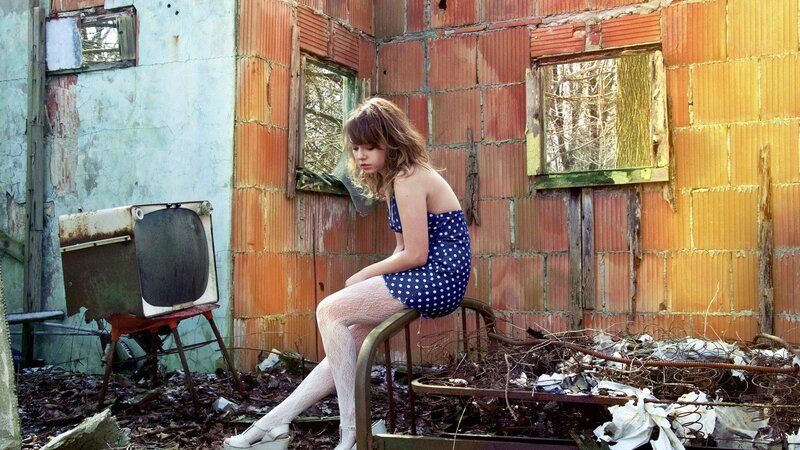 Woman in polka-dot dress sitting