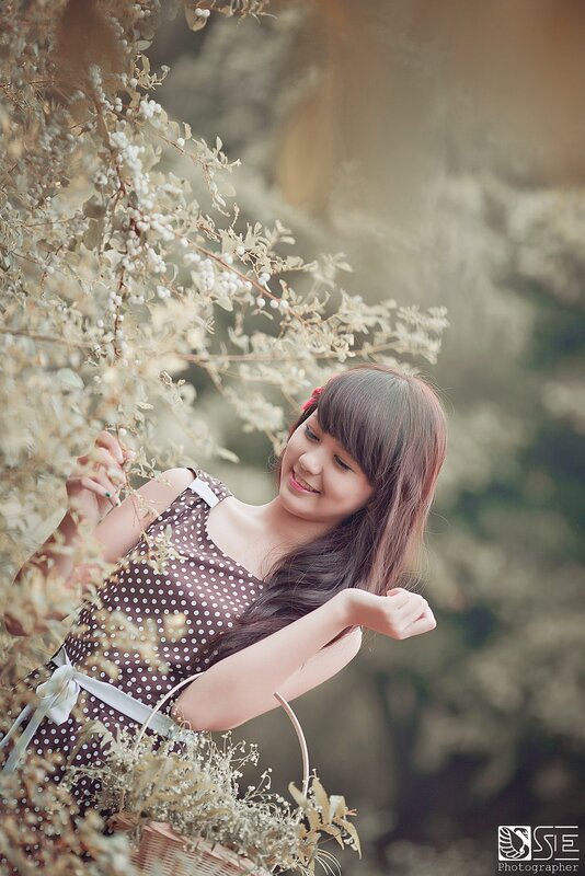 woman in polka dot dress with flowers