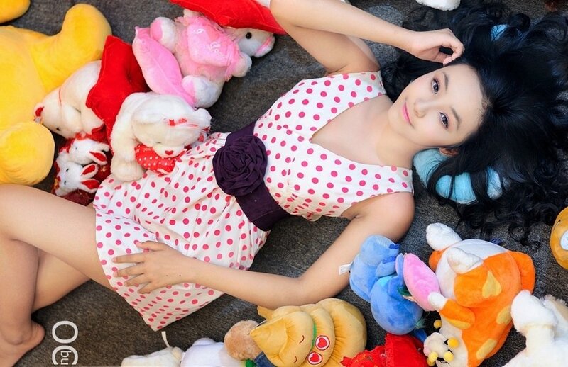 Woman in polka dot dress with stuffed animals