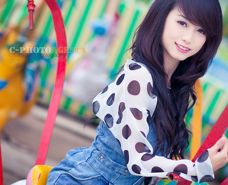 woman in polka-dot shirt at amusement park