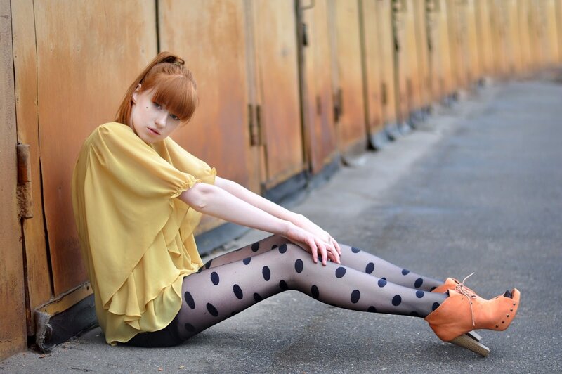 Woman in polka dot tights sitting
