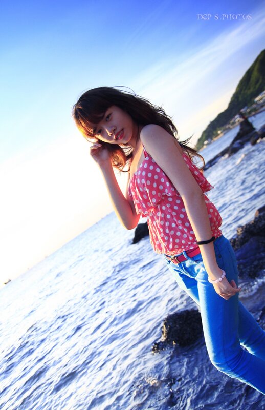 woman in polka dot top at beach