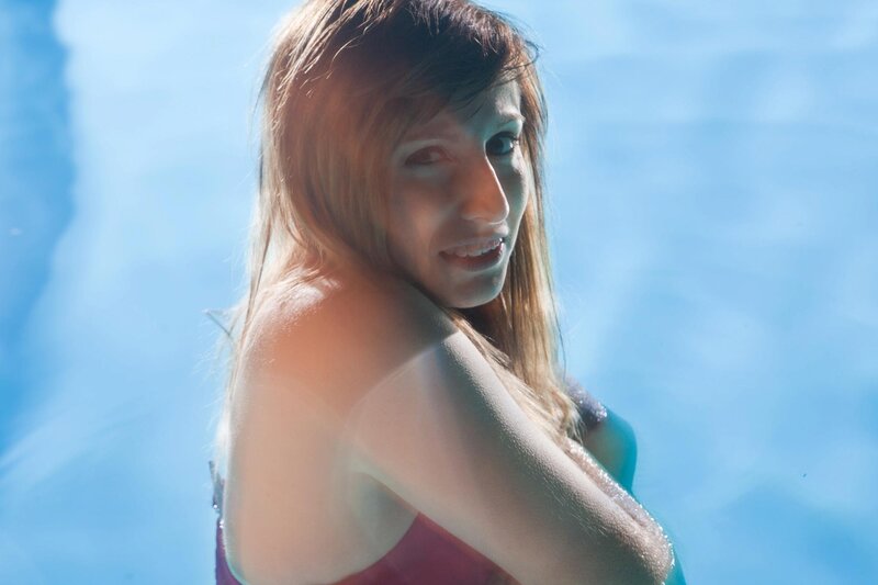 woman in pool at sunset