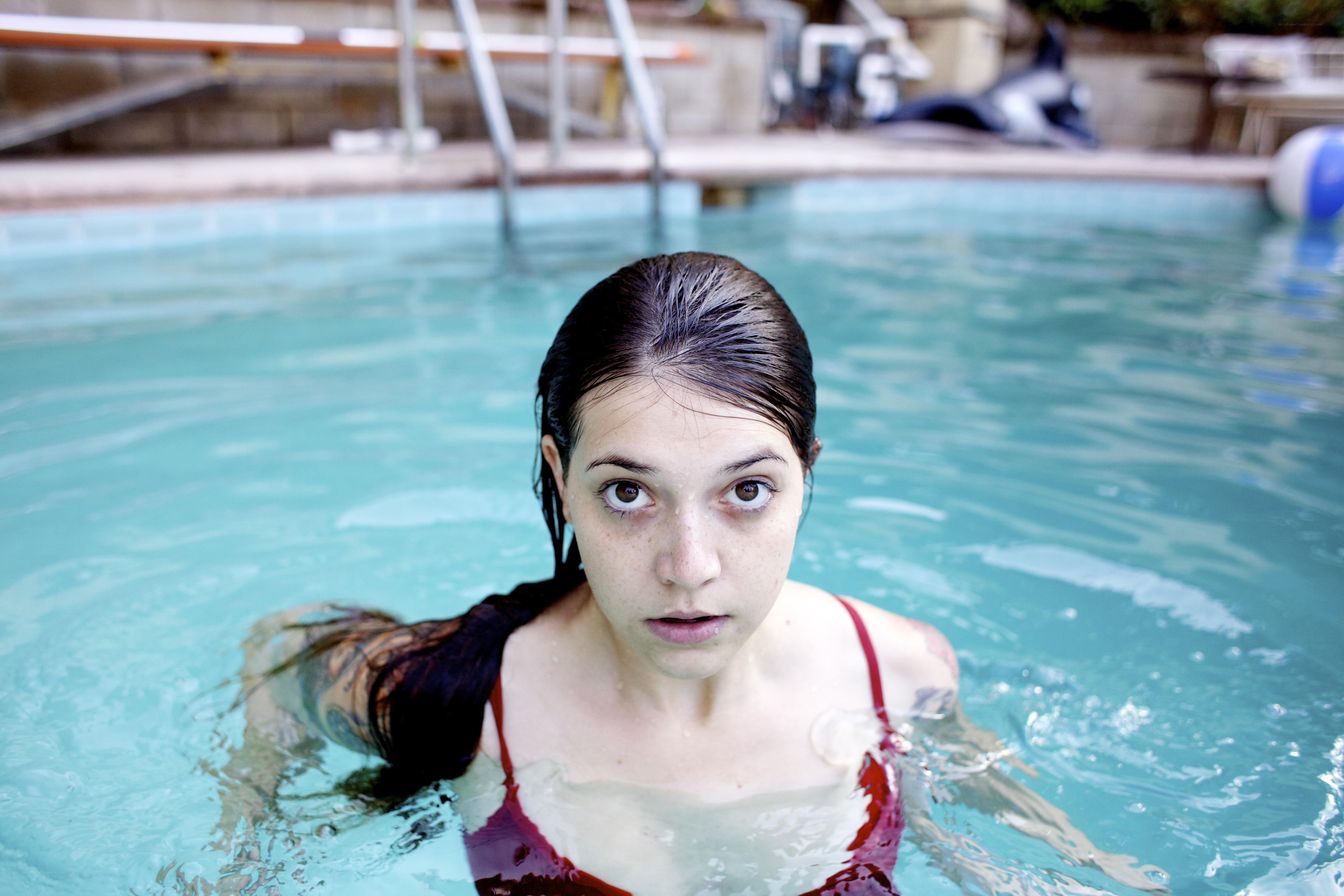 woman in pool looking at camera