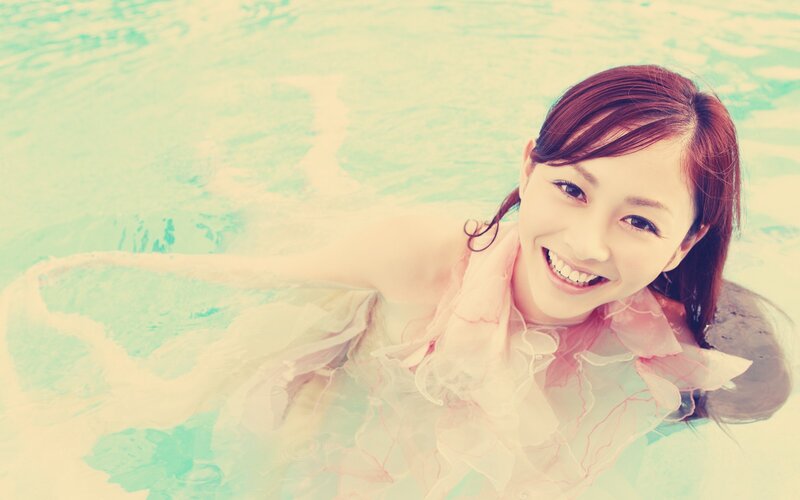 woman in pool smiling