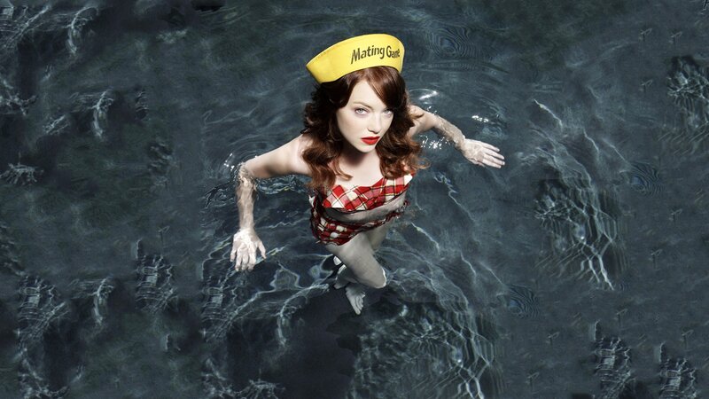 woman in pool wearing hat