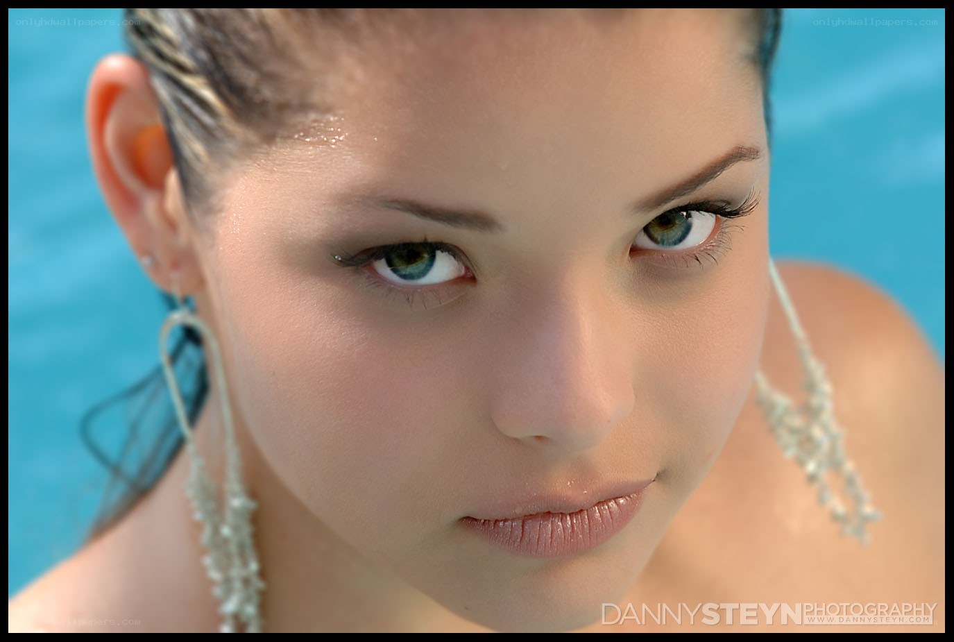 woman in pool with earrings
