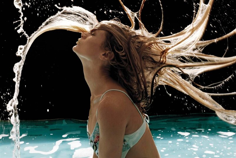 woman in pool with hair flying