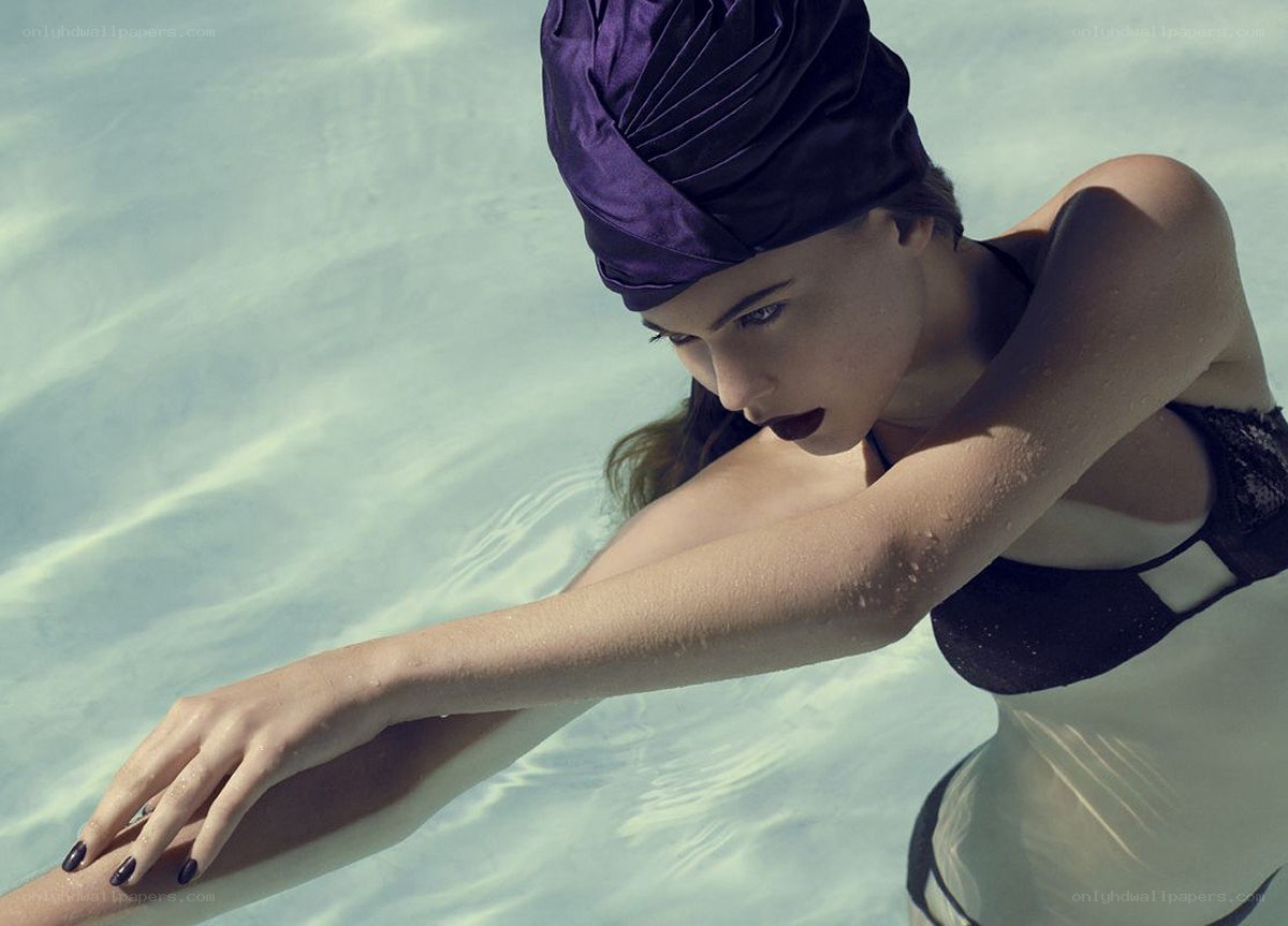 woman in pool with purple headwrap