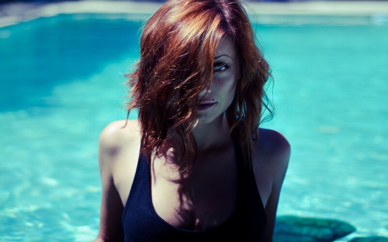 woman in pool with red hair