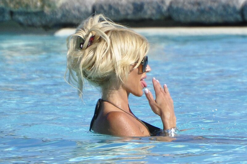 woman in pool with sunglasses