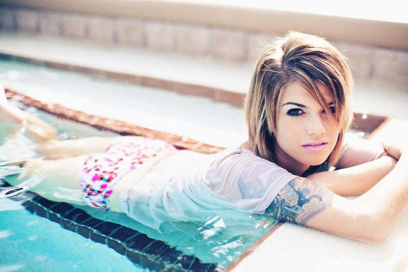 woman in pool with tattoo