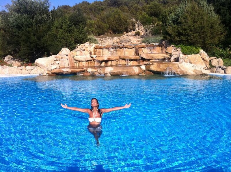 Woman in pool with waterfall