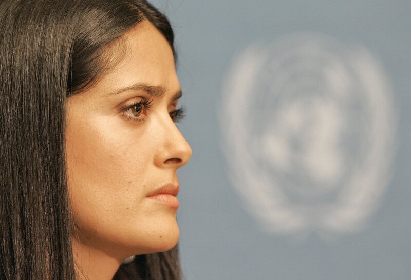 woman in profile at press event