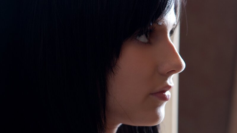 woman in profile by window