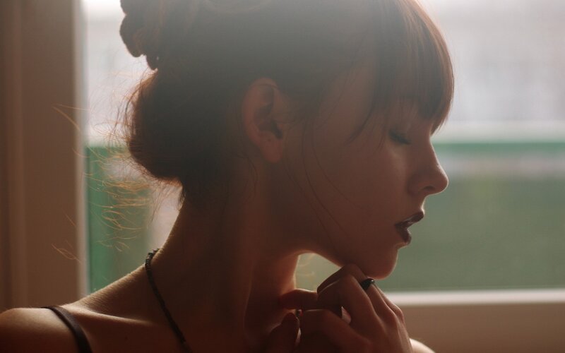 woman in profile by window