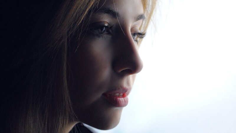 woman in profile by window