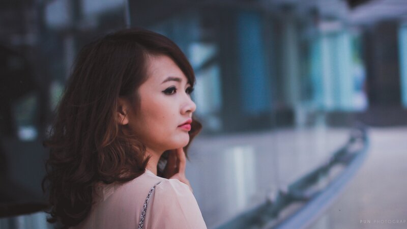 woman in profile on a bridge