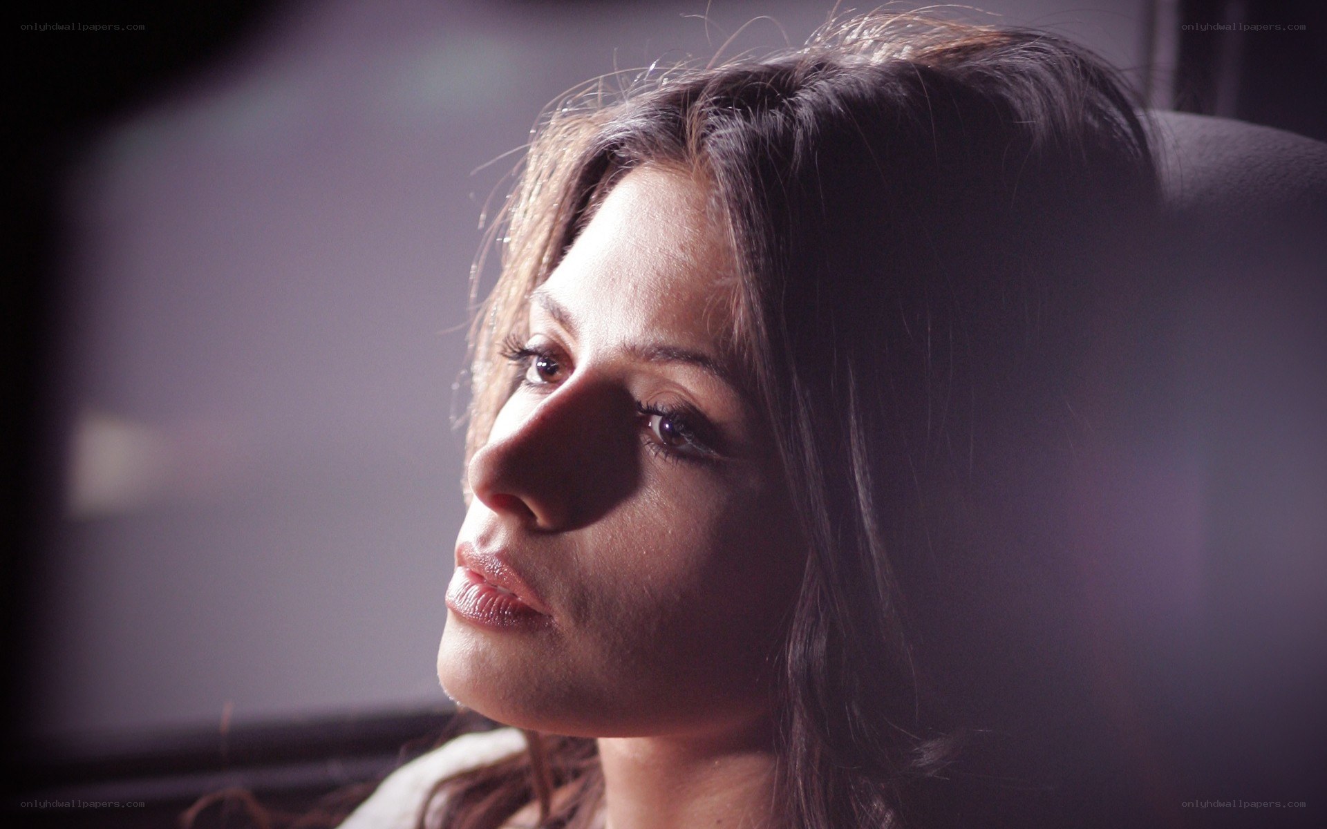 woman in profile with dramatic lighting