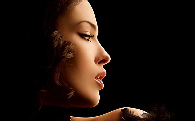 woman in profile with feathers