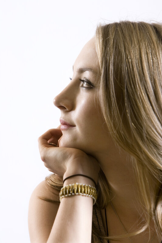 woman in profile with hand on chin