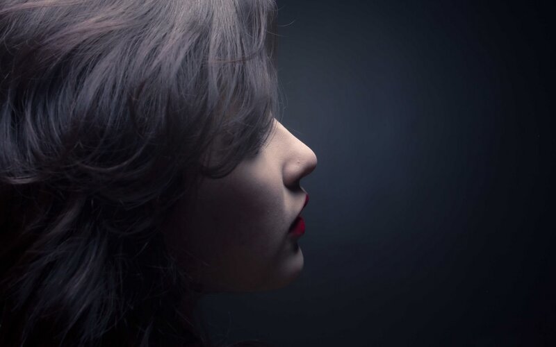 woman in profile with red lips