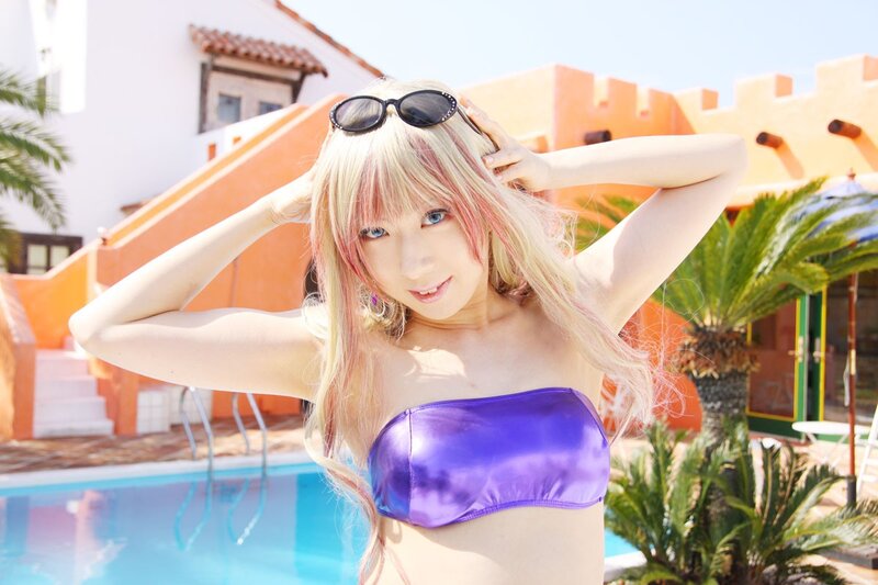Woman in purple bikini by pool