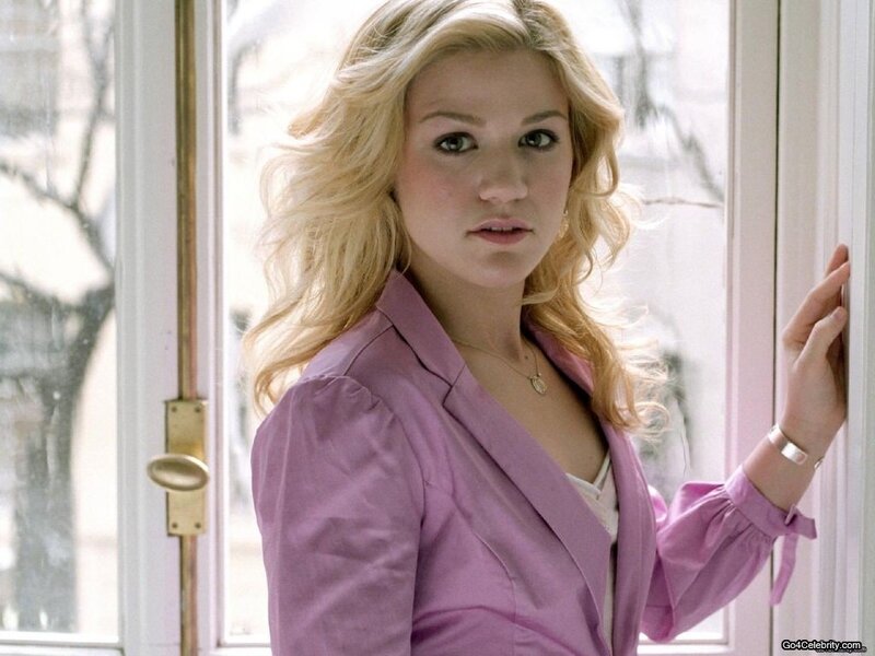 woman in purple blazer by window