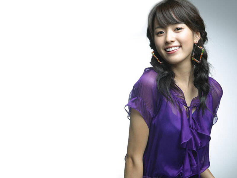 woman in purple blouse smiling